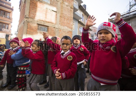 KATHMANDU, NEPAL - DEC 22, 2013: Unknown pupils during dance lesson in primary school. Only only 25% of girls attend schools and half of the children can reach the 5 grade.