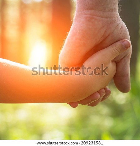 Hands, father with his son close-up, outdoors.