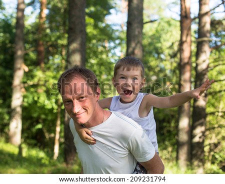 Father with his son play in the Park.