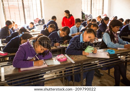 KATHMANDU, NEPAL - DEC 19, 2013 : Unknown children in the lesson at public school. Adult literacy (age 15+) 60.3% (female: 46.3%, male: 73%) in a 2010 population census.