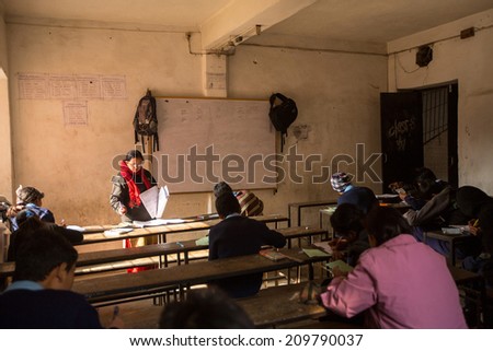 KATHMANDU, NEPAL - DEC 19, 2013 : Unknown children in the lesson at public school. Adult literacy (age 15+) 60.3% (female: 46.3%, male: 73%) in a 2010 population census.
