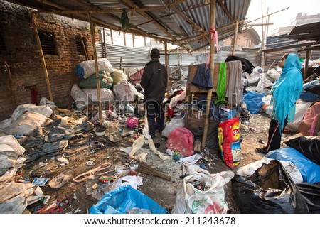 KATHMANDU, NEPAL - DEC 19, 2013: Unidentified people from poorer areas working in sorting of plastic on the dump. Only 35% of population have access to adequate sanitation.