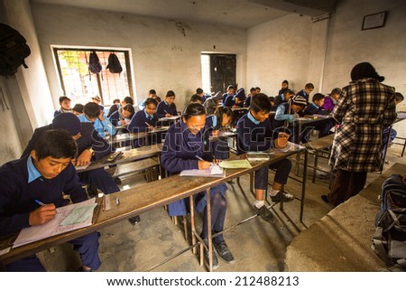 KATHMANDU, NEPAL - DEC 19, 2013: Unknown children in the lesson at public school. Adult literacy (age 15+) 60.3% (female: 46.3%, male: 73%) in a 2010 population census.
