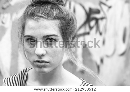 Beautiful fashionable girl close-up portrait, black and white photo.