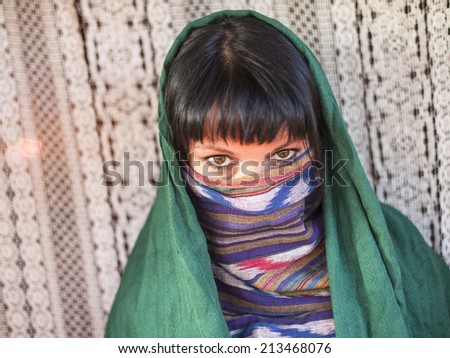 Hijab Portrait of young girl covers her face with a veil Hijab Portrait of young girl covers her face with a veil