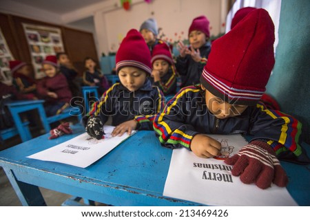 KATHMANDU, NEPAL - DEC 24, 2013: Unknown pupils in English class at primary school. Only 50% of  children in Nepal can reach 5 grade.