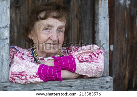 Portrait of old woman in ethnic clothes, outdoors.