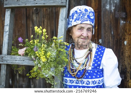 Slavic old woman in ethnic clothes outdoor. Grandmother.