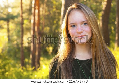 Pretty young girl in forest on a sunny day (with space for text)