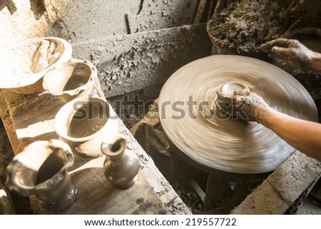 BHAKTAOUR, NEPAL - DEC 7, 2013: Unidentified Nepalese man working in the his pottery workshop. More 100 cultural groups have created an image Bhaktapur as Capital of Nepal Arts.