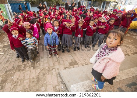 KATHMANDU, NEPAL - DEC 22, 2013: Unknown pupils during dance lesson in primary school. In Nepal only 25% of girls attend schools and half of the children can reach the 5 grade.