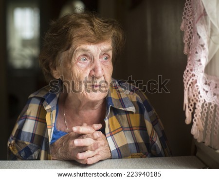 Portrait of a lonely old woman. Caring for the Elderly.