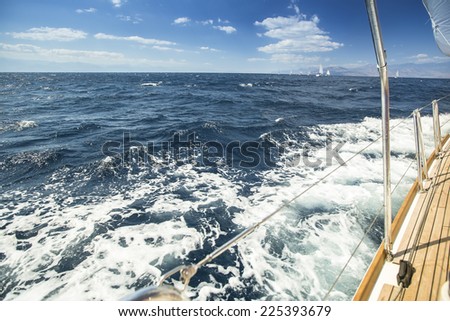 Yachts. Sailing Regatta. Sea waves behind (with space for text or logo)