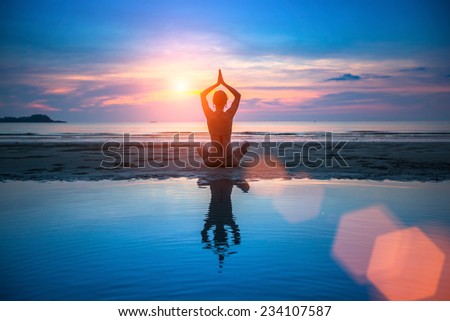 Yoga, silhouette of meditating woman.