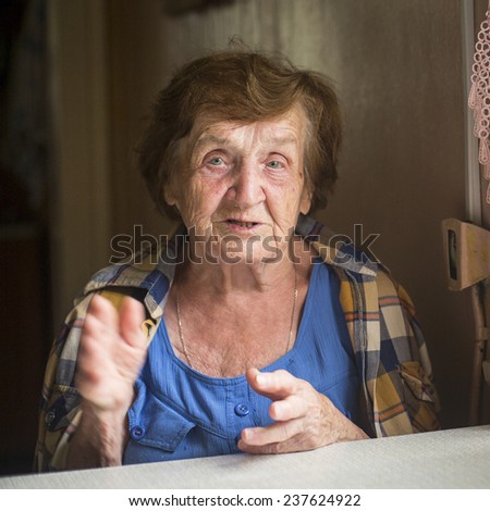 Portrait of an old woman, emotional talking.