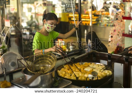 BANGKOK, THAILAND - DEC 15, 2014: Unidentified woman seller on street market in Bangkok. There is 16,000 registered street vendors in Bangkok.