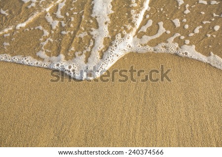 Beach sand texture with soft waves.