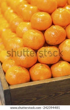 Ripe tasty tangerines in wooden box, Close-up.