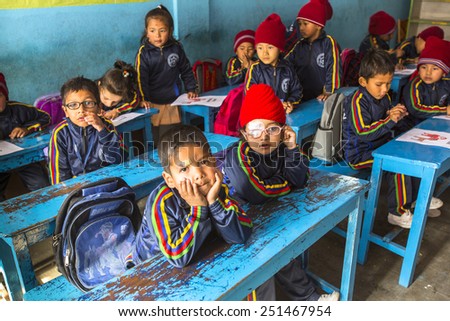KATHMANDU, NEPAL - CIRCA DEC, 2013: Unknown pupils in English class at primary school. Only 50% of  children in Nepal can reach 5 grade.