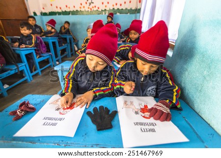 KATHMANDU, NEPAL - CIRCA DEC, 2013: Unknown pupils in English class at primary school. Only 50% of  children in Nepal can reach 5 grade.