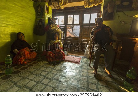 BHAKTAPUR, NEPAL - CIRCA DEC, 2013: Unidentified poor people in his house. The caste system is still intact today but the rules are not as rigid as they were in the past.