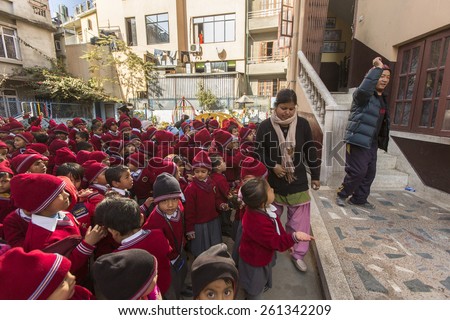 KATHMANDU, NEPAL - CIRCA DEC, 2013: Unknown pupils during dance lesson in primary school. In Nepal only 25% of girls attend schools and half of the children can reach the 5 grade.