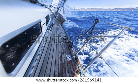 Sailing. Racing yacht in the Mediterranean sea on blue sky background. Luxury Lifestyle.