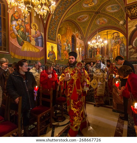 ATHENS, GREECE - APR 12, 2015: Unknown people during celebration of Orthodox Easter (Midnight Office of Pascha) Holy Saturday is often the only time that the Midnight Office will be read in parishes.