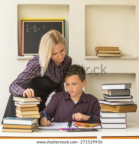 Young student learns at home with a his tutor.