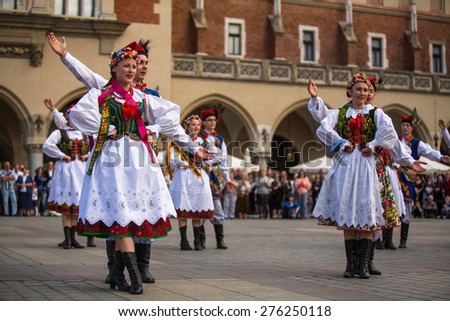 KRAKOW, POLAND - MAY 3, 2015: Polish folk collective on Main square during annual Polish national and public holiday the Constitution Day - May 3, 1791 was adopted first Constitution of modern Europe.