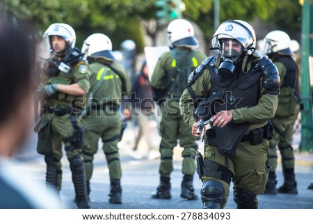ATHENS, GREECE - CIRCA APR, 2015: Riot police with their shield, take cover during a rally in front of Athens University, which is under occupation by protesters leftist and anarchist groups.