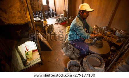 BHAKTAPUR, NEPAL - CIRCA DEC, 2013: Unidentified Nepalese man working in the his pottery workshop. More 100 cultural groups have created an image Bhaktapur as Capital of Nepal Arts.