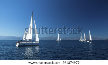 Ship yachts with white sails in the open Sea. Boats in sailing regatta. Sailing yacht race.