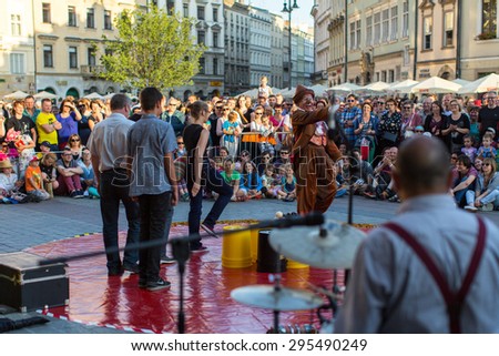 KRAKOW, POLAND - JUL 11, 2015: Unidentified participants at the 28th International Festival of Street Theatres. Annually July 9-12 performances in the Main Square and at random points around the city.