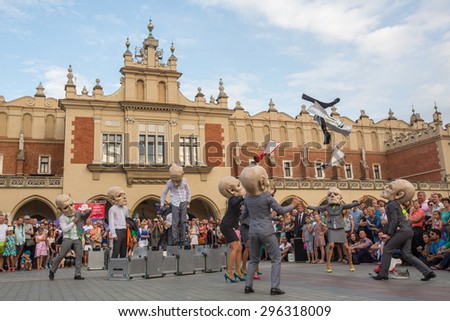KRAKOW, POLAND - JUL 12, 2015: Participants at the annually (Jul 9-12) 28th International Festival of Street Theatres - Teatr KTO (PL) Peregrinus in Main Square and at random points around the city.
