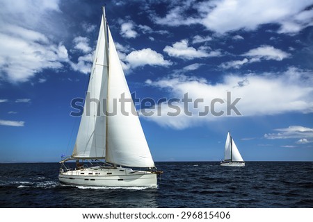 Ship yachts with white sails in the open sea. Sailing. Yachting. Luxury Lifestyle.