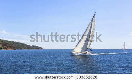 Sailing. Ship yachts with white sails in the Sea. Luxury boats.