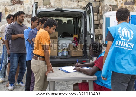 KOS, GREECE - SEP 27, 2015: War refugees are registered employees of the UNHCR. Kos island is located just 4 kilometers from the Turkish coast, and refugees come from Turkey on inflatable boats.