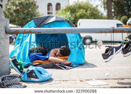 KOS, GREECE - SEP 28, 2015: Unidentified refugees sleep in tents. More than half are migrants from Syria, but there are refugees from other countries -Afghanistan, Pakistan, Iraq, Iran, Mali, Eritrea.