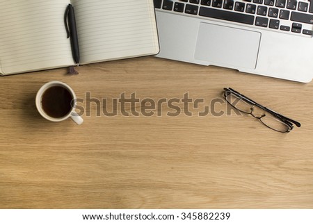 Notepad with pen and laptop on wooden table. Picture with space for your text.