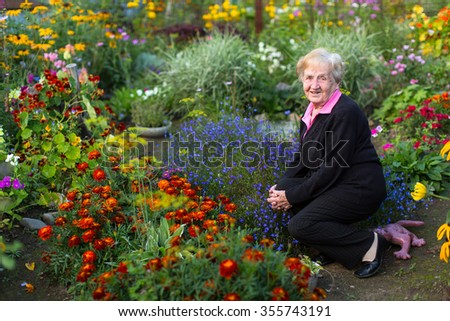 An old grandmother was sitting in the flower garden.