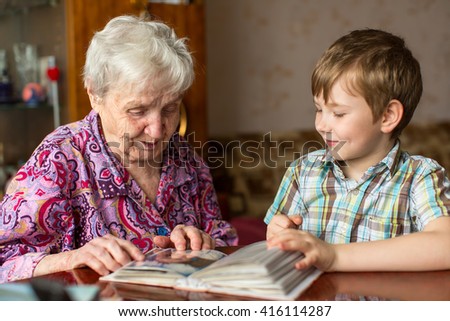 Grandmother and grandson looking photo album.