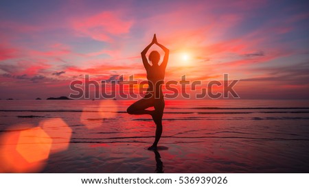 Meditation girl on the sea during sunset. Yoga silhouette. Fitness and healthy lifestyle.