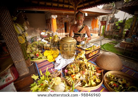 BALI, INDONESIA - MARCH 28: Hindu Brahmin during the ceremonies of Oton - is the first ceremony for baby\'s on which the infant is allowed to touch the ground on March 28, 2012 on Bali, Indonesia.