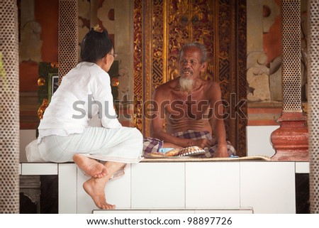 BALI, INDONESIA - MARCH 28: Hindu Brahmin before start ceremonies of Oton - is the first ceremony for baby\'s on which the infant is allowed to touch the ground on March 28, 2012 on Bali, Indonesia.