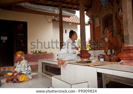 BALI, INDONESIA - MARCH 28: Hindu Brahmin befor the ceremonies of Oton - is the first ceremony for baby\'s on which the infant is allowed to touch the ground on March 28, 2012 on Bali, Indonesia.
