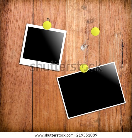 polaroid photo frames on wooden wall background