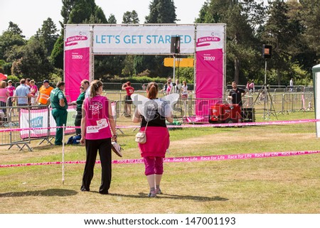 SOUTHAMPTON, UK - JULY 14: Women start to gather for the annual Race for Life to raise money for Cancer Research on July 14, 2013 in Southhampton, UK.