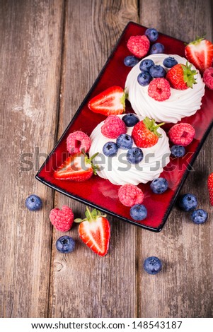 Summer fruit platter over old wood. Vintage style processing with intentional vignetting