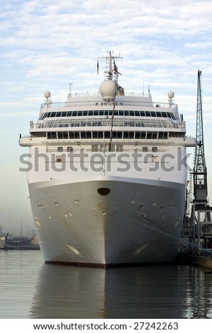 White cruise ship in port of Southampton UK. Crane alongside gives good indication of scale